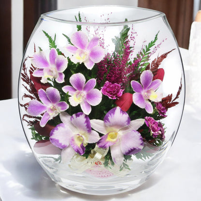 Elegant Purple Orchids in Rugby Glass Vase with Greenery