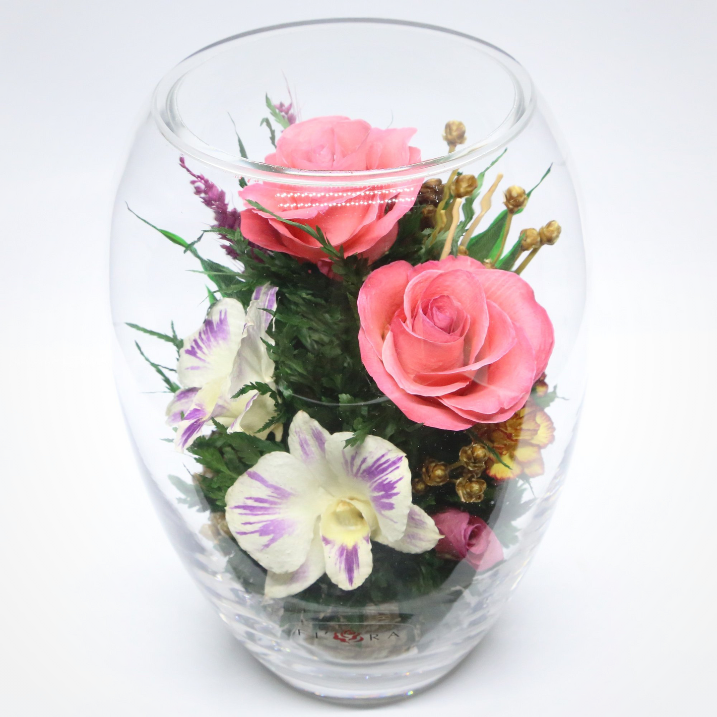 61097 Long-Lasting Pink Roses, Purple-Striped White & King Dragon Orchids, Orange Spray Carnations in an Elliptical Glass Vase